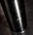 Derange Red Wine bottle on a black and gray background up close