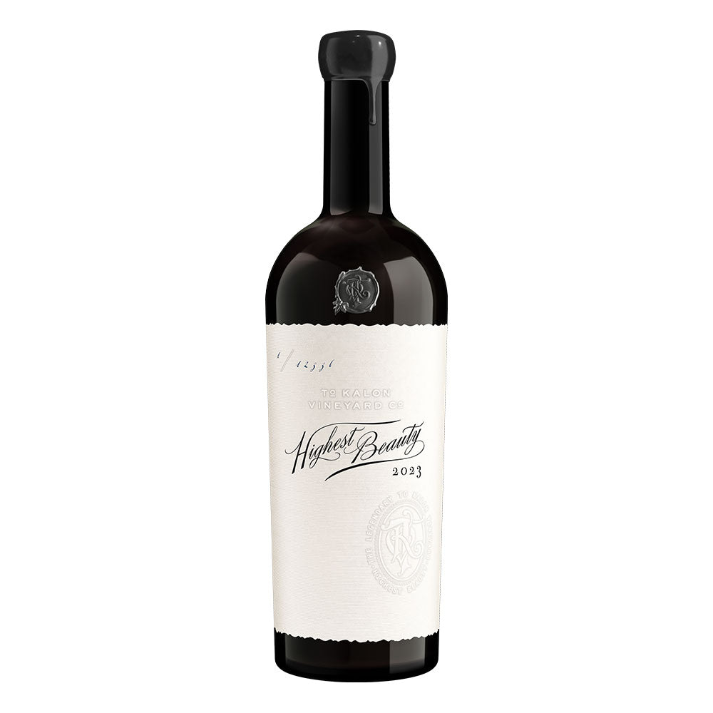 A bottle of Highest Beauty 2023 red wine from To Kalon Vineyard Co., featuring a dark glass bottle with a black cap and a large white label.