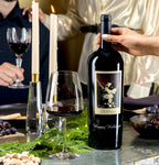 The Prisoner Red Blend Magnum Etched with "Happy Holidays" on a table