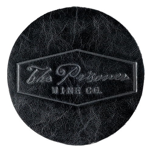 The Prisone Logo black leather coaster on a blank background