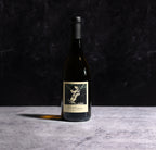 A Bottle Of  2022 The Prisoner Chardonnay Carneros Wine On A Gray Background